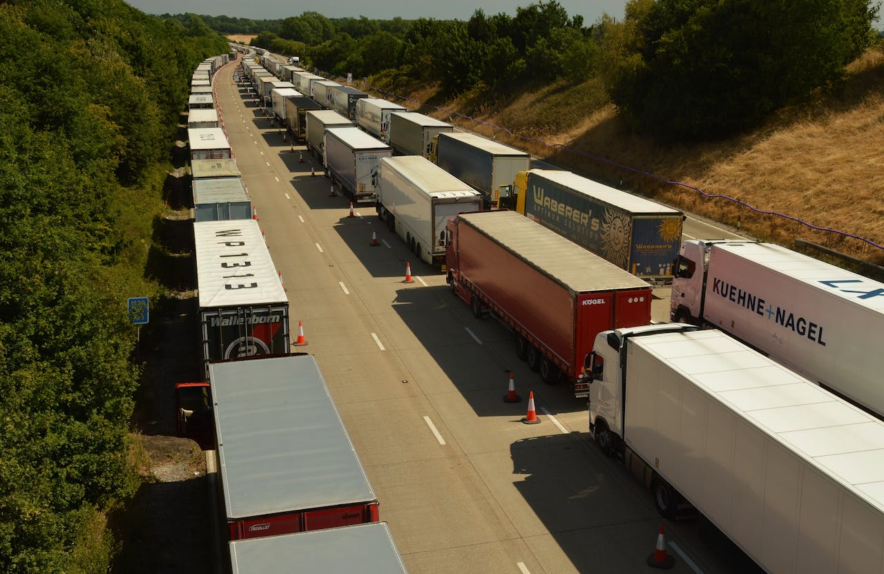 Services Drone shot capturing traffic jam of trailer trucks on a highway in England.